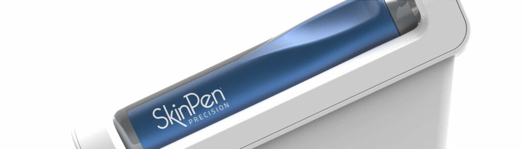 Dermal pen labeled SkinPen Precision shown at an angled view on a white surface used for microneedling treatment